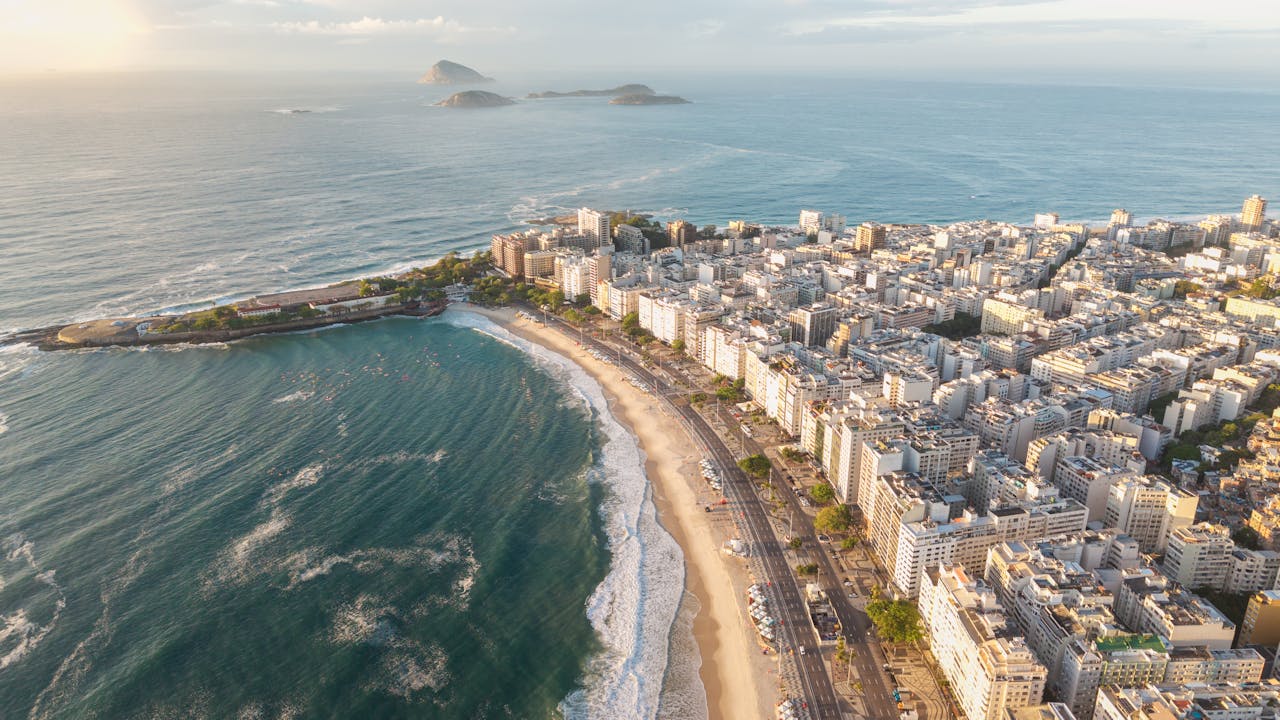 Stunning aerial shot of Copacabana Beach in Rio de Janeiro during golden sunset light.