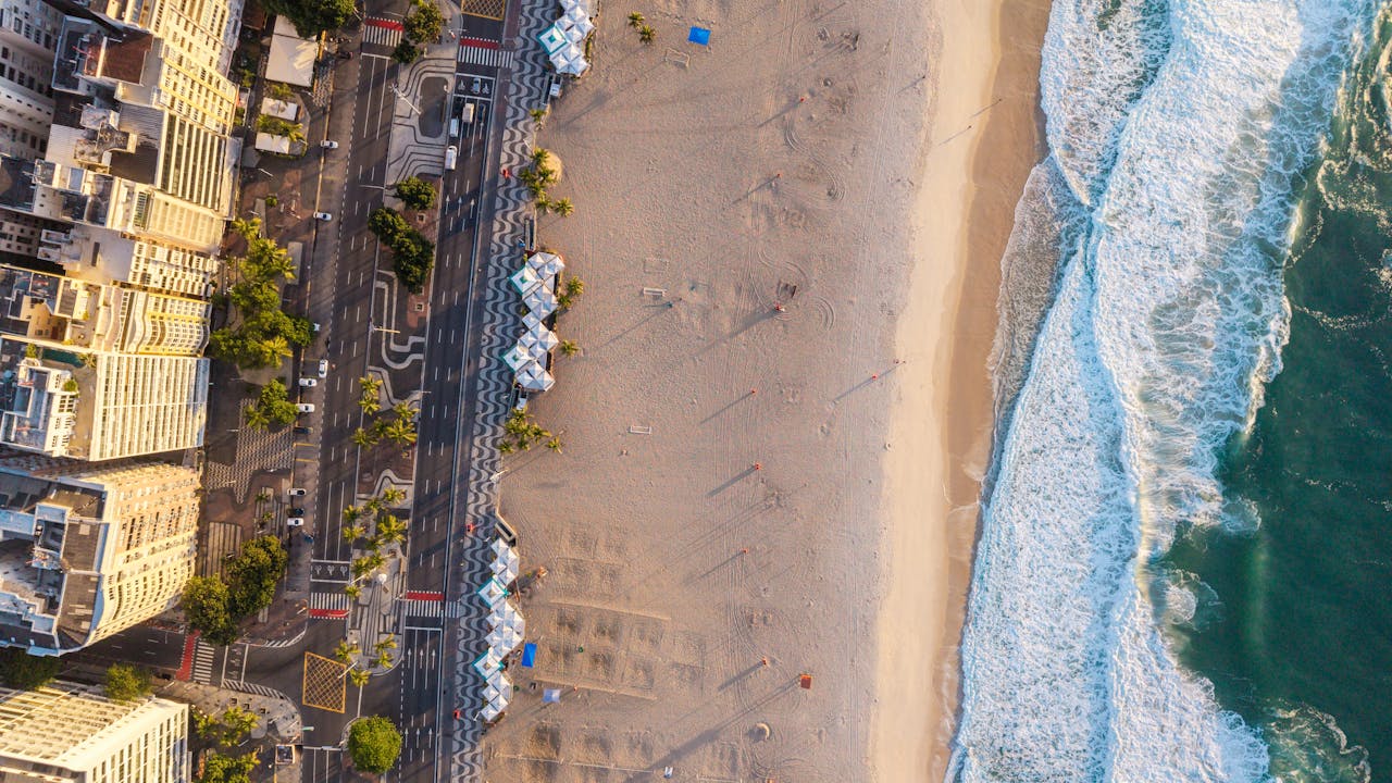 A stunning aerial shot showcasing Rio de Janeiro's scenic beachfront at sunset, with golden sands and cityscape.